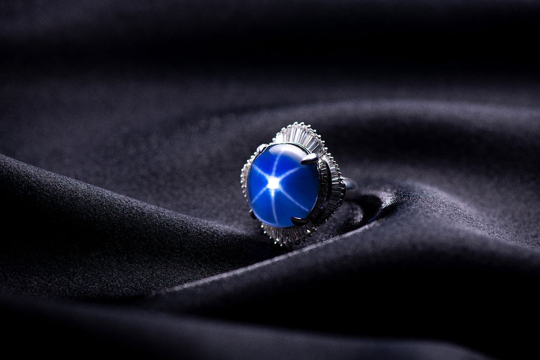 JUSTLEE collection: star sapphire exhibiting asterism and colour-change effect — silk inclusions forming a six-rayed star