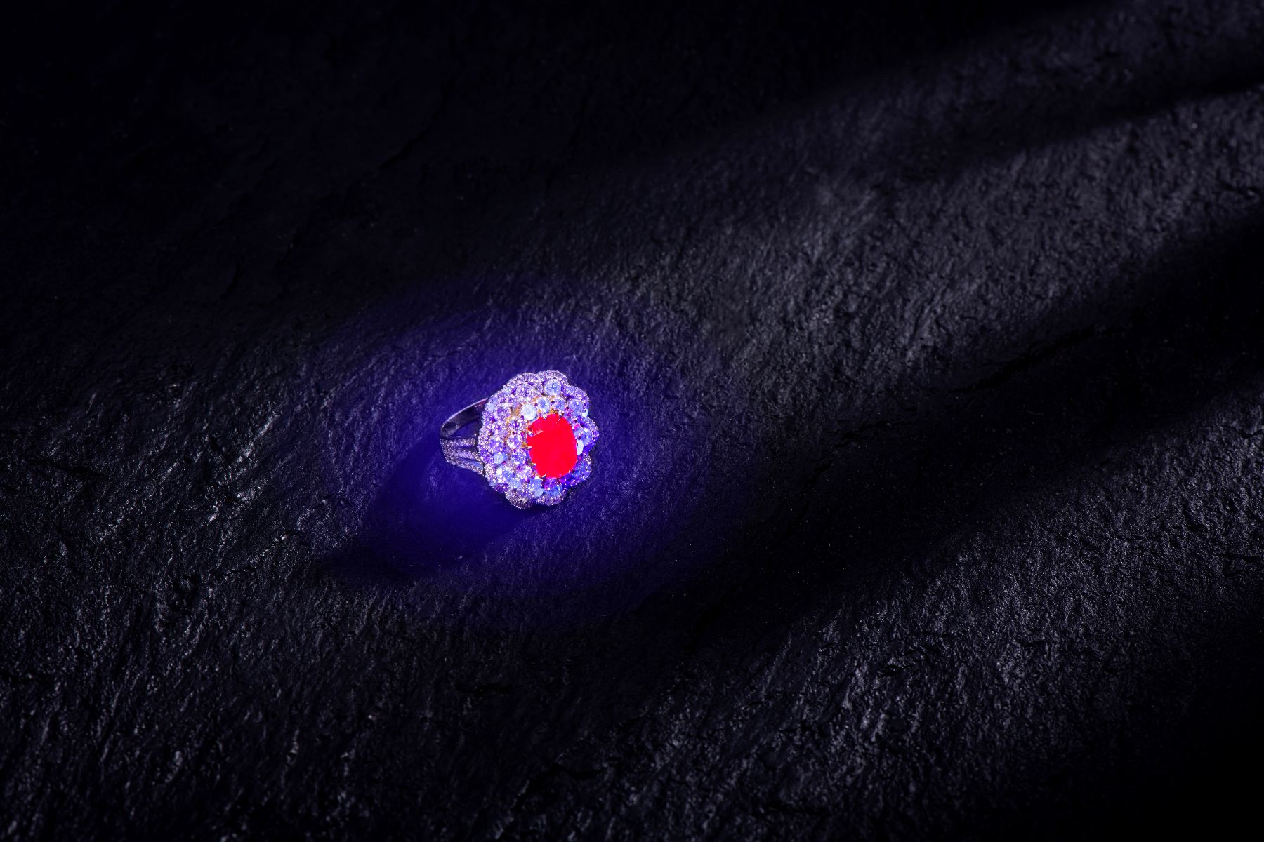 Mogok ruby under long-wave ultraviolet light displaying strong red fluorescence — a required condition for GRS pigeon blood designation